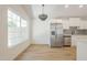 Bright eat-in kitchen featuring stainless steel appliances, modern cabinets, and stylish chandelier at 3701 W Villa Maria Dr, Glendale, AZ 85308