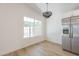 Bright eat-in kitchen features a large window allowing natural light, and modern light fixture at 3701 W Villa Maria Dr, Glendale, AZ 85308