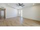 A bright living room with wood-look floors leads to a front door with decorative glass detail at 3701 W Villa Maria Dr, Glendale, AZ 85308