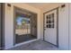 Back patio with sliding glass doors and a white door to the backyard at 3701 W Villa Maria Dr, Glendale, AZ 85308