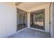 Back patio with sliding glass doors, white walls, and a concrete foundation at 3701 W Villa Maria Dr, Glendale, AZ 85308