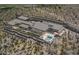 Aerial view of a modern home with a pool, surrounded by desert landscape at 39307 N Silver Saddle Dr, Carefree, AZ 85377