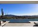 Infinity pool overlooking desert landscape with lounge seating, blue skies at 39307 N Silver Saddle Dr, Carefree, AZ 85377