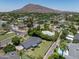 Aerial view of home with a well-manicured lawn, pool, and mountain views at 4125 N 64Th St, Scottsdale, AZ 85251