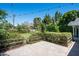 Back patio with string lights, brick pavers, lush greenery, and a charming, cozy atmosphere at 4125 N 64Th St, Scottsdale, AZ 85251