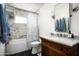 Bathroom featuring a tub, tiled shower, a sink, and decorative fixtures, all with unique style at 4125 N 64Th St, Scottsdale, AZ 85251