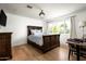 Bedroom showcasing a decorative light fixture, a wooden bed frame, and a quaint workspace at 4125 N 64Th St, Scottsdale, AZ 85251