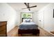 Bedroom featuring a wooden bed frame, a window, and neutral decor with hardwood flooring at 4125 N 64Th St, Scottsdale, AZ 85251
