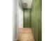 Hallway with stylish olive green storage lockers along the walls and hardwood flooring at 4125 N 64Th St, Scottsdale, AZ 85251