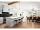 Bright and airy kitchen featuring an island with a quartz countertop, counter seating, and wood floors with a dining area at 4125 N 64Th St, Scottsdale, AZ 85251