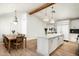 Spacious kitchen with an island, white cabinets, wood floors, dining area, and stainless steel appliances at 4125 N 64Th St, Scottsdale, AZ 85251