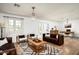 Inviting living room featuring hardwood floors, neutral walls, comfortable leather seating, and a decorative rug at 4125 N 64Th St, Scottsdale, AZ 85251