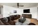 Relax in this living room featuring a leather sofa, hardwood floors, and a modern ceiling fan at 4125 N 64Th St, Scottsdale, AZ 85251