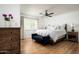 Bright main bedroom with white walls, a ceiling fan, and a large window providing ample natural light at 4125 N 64Th St, Scottsdale, AZ 85251