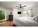 Another view of the main bedroom with a ceiling fan, white walls, and an ensuite entry at 4125 N 64Th St, Scottsdale, AZ 85251