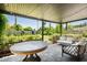 Covered patio with comfortable seating, stylish decor, and views of a lush, green backyard at 4125 N 64Th St, Scottsdale, AZ 85251
