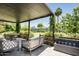 Covered patio featuring an outdoor seating area with a modern water feature and manicured greenery at 4125 N 64Th St, Scottsdale, AZ 85251