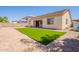 Backyard with artificial turf, block wall and covered patio at 4235 S Snowcap Dr, Gilbert, AZ 85297