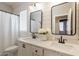 Bright bathroom with dual sinks, white cabinets, marble countertops, and modern fixtures with horizontally laid shiplap at 4235 S Snowcap Dr, Gilbert, AZ 85297