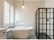 Beautiful bathroom with freestanding tub, glass-enclosed shower, and stylish tile work at 4235 S Snowcap Dr, Gilbert, AZ 85297