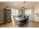Open-concept dining area with wood floors, modern light fixture, and view of kitchen at 4235 S Snowcap Dr, Gilbert, AZ 85297