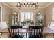Elegant dining room with a wooden table, stylish chairs, and a modern light fixture at 4235 S Snowcap Dr, Gilbert, AZ 85297