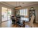 Bright dining area with a farmhouse-style table, hardwood floors, and lots of natural light at 4235 S Snowcap Dr, Gilbert, AZ 85297