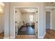Spacious exercise room with double doors, rubber flooring, weight bench, and natural light from a window at 4235 S Snowcap Dr, Gilbert, AZ 85297