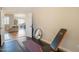 Exercise room featuring a weight bench, rubber flooring, and an open doorway leading to the living room and dining area at 4235 S Snowcap Dr, Gilbert, AZ 85297