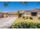 Charming single-story home featuring a well-manicured lawn, desert landscaping, and a spacious two-car garage at 4235 S Snowcap Dr, Gilbert, AZ 85297