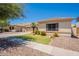 Charming single-story home featuring a well-manicured lawn, desert landscaping, and a spacious two-car garage at 4235 S Snowcap Dr, Gilbert, AZ 85297