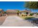Charming single-story home featuring a well-manicured lawn, desert landscaping, and a spacious two-car garage at 4235 S Snowcap Dr, Gilbert, AZ 85297