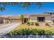 Charming single-story home featuring a well-manicured lawn, desert landscaping, and a spacious two-car garage at 4235 S Snowcap Dr, Gilbert, AZ 85297