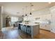 Bright, open kitchen with a large center island, bar stool seating, and stainless steel appliances at 4235 S Snowcap Dr, Gilbert, AZ 85297