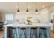 Modern kitchen with white subway tile, custom cabinetry, pendant lighting, and a large island at 4235 S Snowcap Dr, Gilbert, AZ 85297