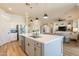 Open concept kitchen with center island and views to living area and adjacent stainless steel appliances at 4235 S Snowcap Dr, Gilbert, AZ 85297