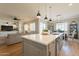 Open concept kitchen with a center island that connects to the living room and dining area at 4235 S Snowcap Dr, Gilbert, AZ 85297