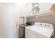 Clean laundry area with modern washer and dryer, plenty of storage and easy access to the door at 4235 S Snowcap Dr, Gilbert, AZ 85297