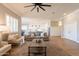 Open living room with neutral tones, hardwood floors, ceiling fan, and comfortable furniture at 4235 S Snowcap Dr, Gilbert, AZ 85297