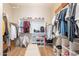 Organized walk-in closet featuring custom shelving, hanging rods, and a central bench for optimal storage at 4235 S Snowcap Dr, Gilbert, AZ 85297