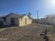 The gravel backyard features a block wall and small trees at 4304 N 55Th Dr, Phoenix, AZ 85031