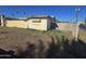 Unkept grass shows a vacant backyard with block wall and overgrown weeds at 4304 N 55Th Dr, Phoenix, AZ 85031