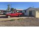 Red truck in driveway of home with boarded up windows and missing siding at 4304 N 55Th Dr, Phoenix, AZ 85031
