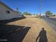 Shadow covers vacant lot next to boarded up home with dead landscaping at 4304 N 55Th Dr, Phoenix, AZ 85031