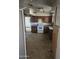 A dated kitchen, with damage in the walls and floor at 4304 N 55Th Dr, Phoenix, AZ 85031