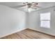 Bright bedroom with wood-look flooring, a ceiling fan, and window at 4344 W Kimberly Way, Glendale, AZ 85308