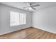 Bright bedroom with wood-look flooring and a modern ceiling fan fixture at 4344 W Kimberly Way, Glendale, AZ 85308