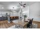 Open-concept dining area with modern chandelier lighting and convenient flow into the bright white kitchen at 4344 W Kimberly Way, Glendale, AZ 85308