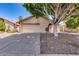 Charming single-story home featuring a two-car garage, mature shade tree, and low-maintenance landscaping at 4344 W Kimberly Way, Glendale, AZ 85308