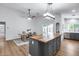 Spacious kitchen seamlessly connects to the dining area, featuring modern appliances and a stylish dining table at 4344 W Kimberly Way, Glendale, AZ 85308